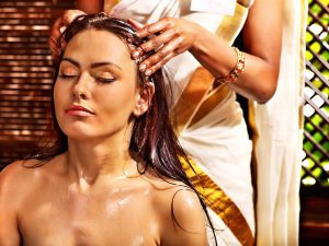 Young woman having head ayurveda spa treatment.